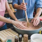 "A collection of handmade soaps in vibrant colors, showcasing natural textures and ingredients, representing the art of soap making."